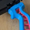 Close-up detail of the Skelethal launcher grip surface texture, showing grip patterning for improved control during launches