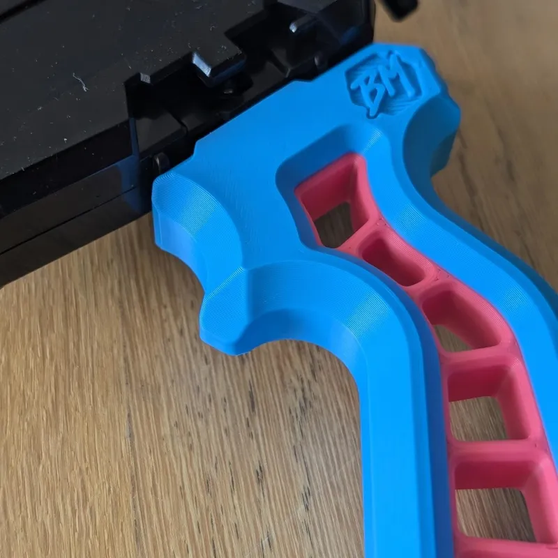 Close-up detail of the Skelethal launcher grip surface texture, showing grip patterning for improved control during launches