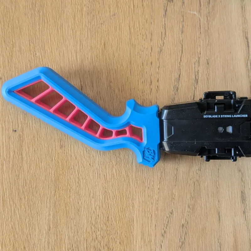 Front compatibility view showing how the launcher grip connects with Beyblade X systems for winder and string launcher use