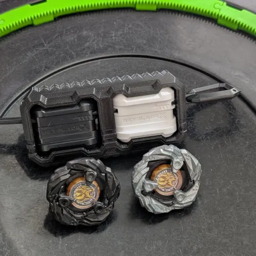 the setup including dual beyblade X launcher and two beyblades, one is painted black