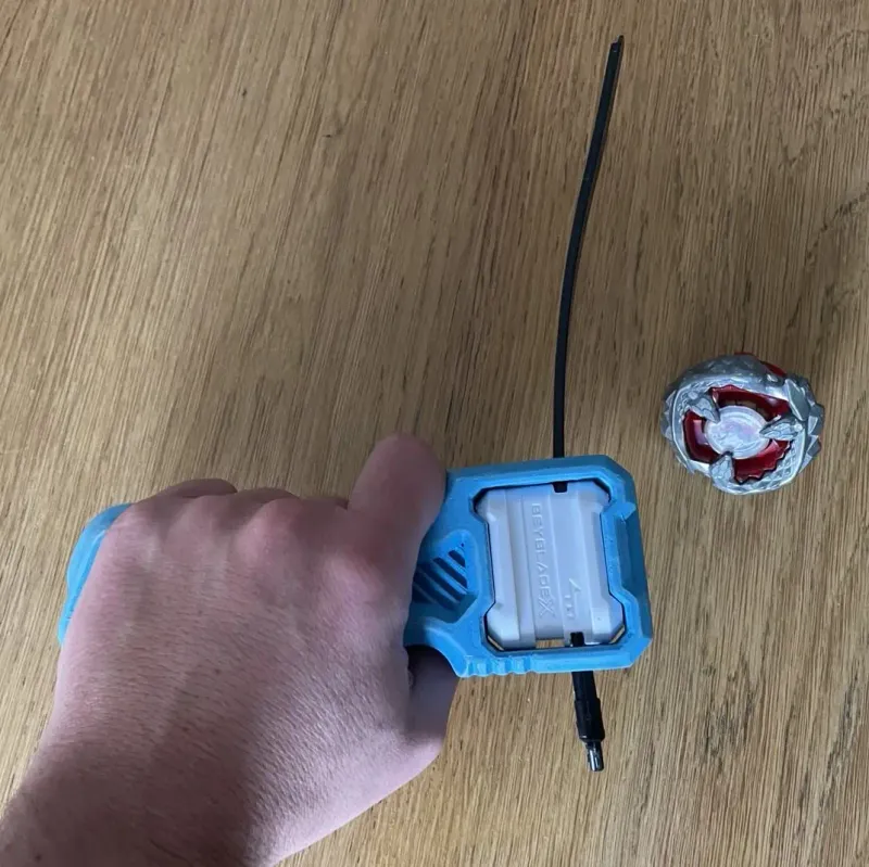 Top view of Bakuten Proto Launcher Grip held in hand for ergonomic demonstration