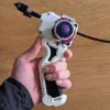 Bottom view of 3D printed Bakuten-style Beyblade X grip in hand with a beyblade loaded