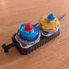 Bottom view of Beyblade X inline dual launcher grip showing launcher slots