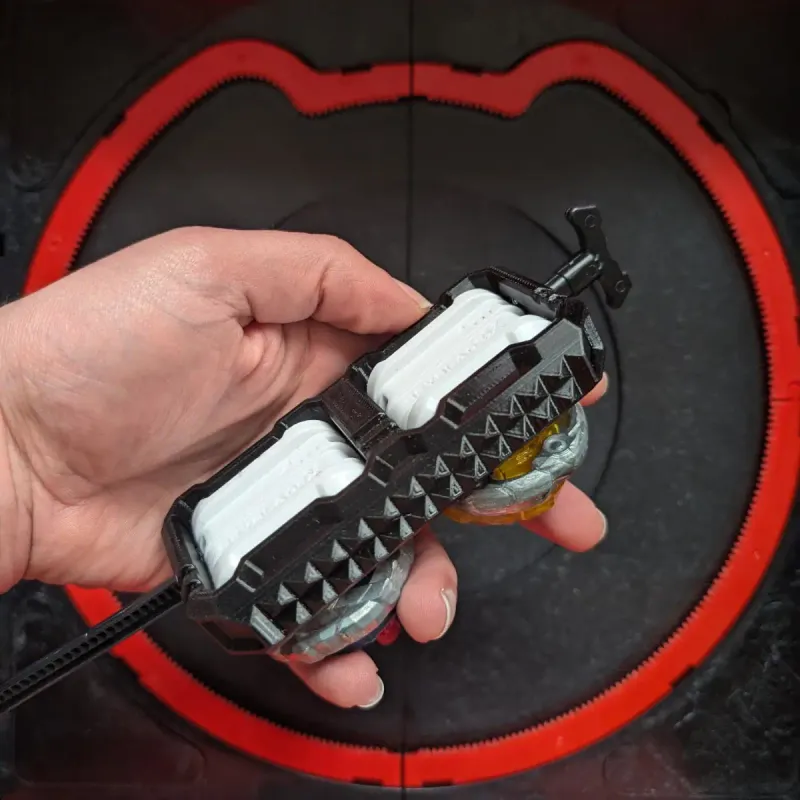 Top view of a hand using Beyblade X inline dual launcher grip in use with two beyblades