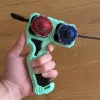 Inline Modular Dual Proto Launcher Grip held in left hand with two Beyblade X tops loaded