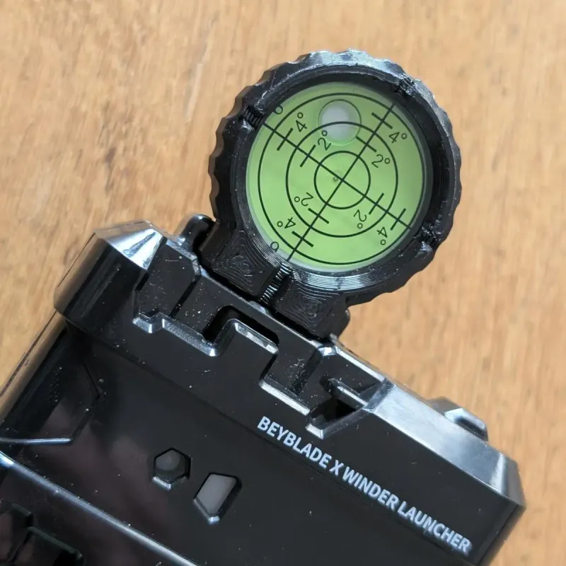 A beyblade X winder launcher with the leveling scope mounted