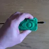 Hand holding Beyblade X Proto Launcher with custom Bakuten style grip during launch