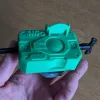 Hand holding Beyblade X Proto Launcher with custom Bakuten style grip