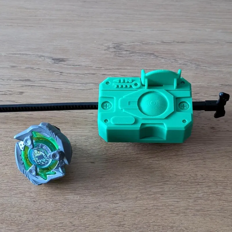 Beyblade X Proto Launcher with custom Bakuten style grip viewed from the top, with a beyblade on the side