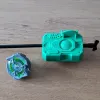 Beyblade X Proto Launcher with custom Bakuten style grip viewed from the top, with a beyblade on the side