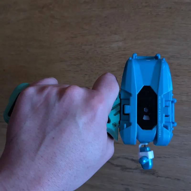 Beyblade X Skelethal Winder Launcher Grip held in hand demonstrating ergonomic shape