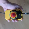 Player holding custom Beyblade X inline launcher grip designed for competitive launch control